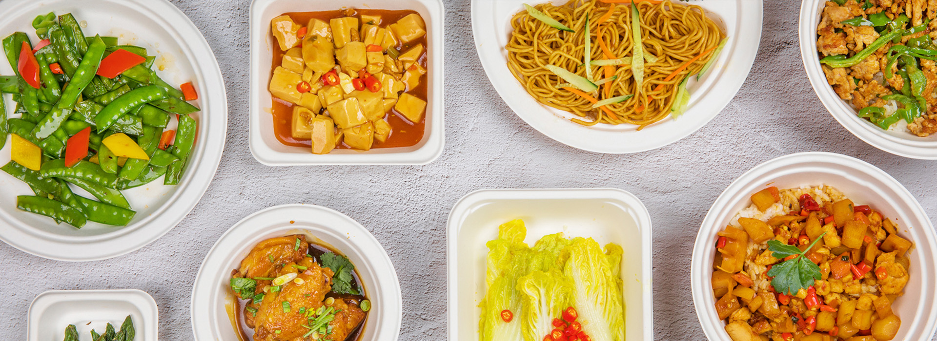 Variety of dishes plated in Gotvoom molded-fibre bowls, plates and trays